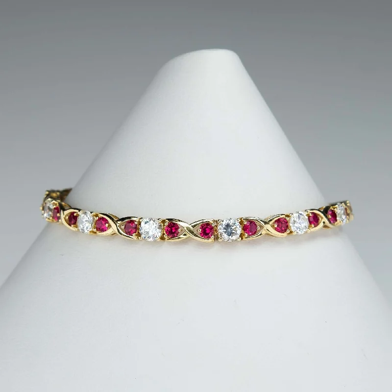 Tiny wing bangles-Cubic Zirconia and Red Spinel "X"Link Tennis Bracelet is 14K Yellow Gold